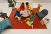 A family gathered around a table for family game night playing together on the Board
